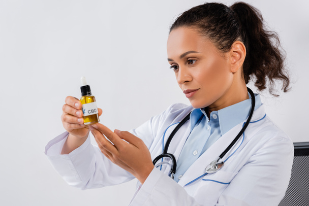 african american doctor holding cbd bottle in clinic - Photo, Image
