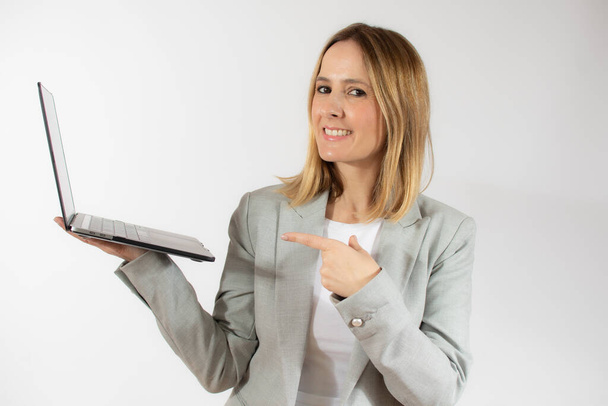 Obchodní mladá žena drží notebook přes bílé pozadí - Fotografie, Obrázek