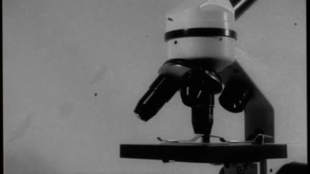 Aged video, filmed movement around a microscope with three black lenses and an instrument table - Πλάνα, βίντεο