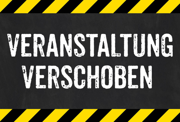 Sign with caution stripes - Event postponed in german - Veranstaltung verschoben - Photo, Image