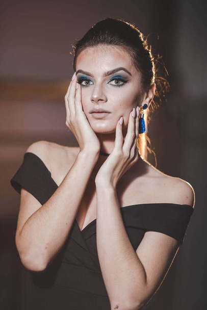 An attractive Bosnian Caucasian woman with blue eye makeup against a bright light background - Zdjęcie, obraz
