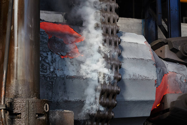   Suurikapasiteettiset teräsharkko käsitellään taonta paina. Taonta tuotanto. Metallurgia - Valokuva, kuva