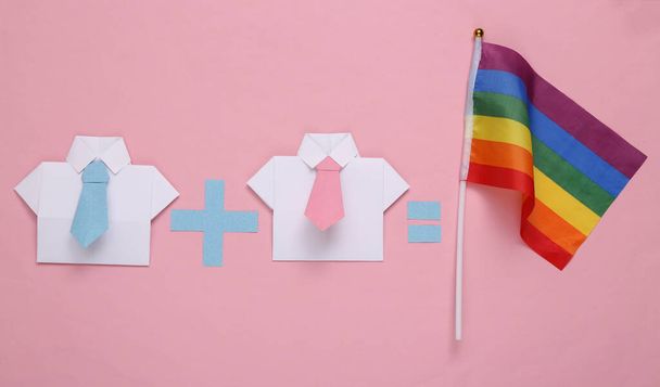 LGBT gay relationships. Equation with two male origami shirt and rainbow flag on pink background - Photo, Image