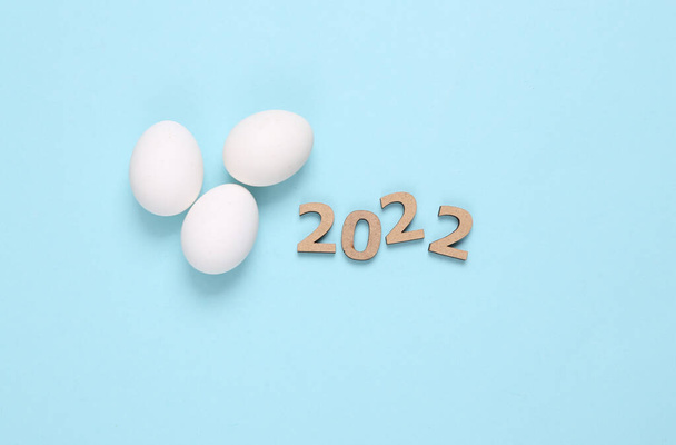 Eggs and 2022 on blue background. Easter 2022 - 写真・画像