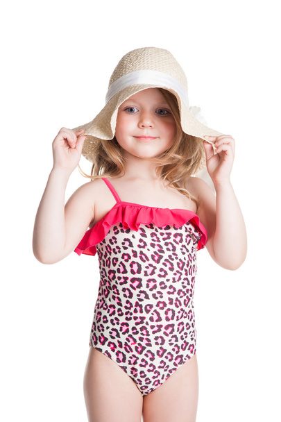 little blonde happy girl in pink swimsuit holding hat  - Photo, image