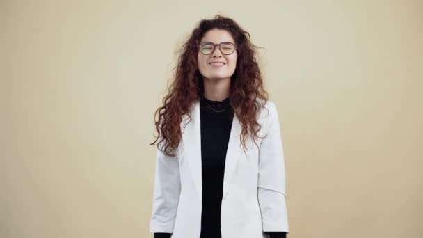 The young woman who smiles with her curly hair, her nose twists forward, emits the fact that she is spiteful. Young hipster in gray jacket and white shirt, - Footage, Video
