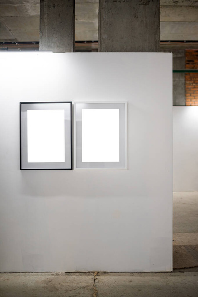 Mock up. Blank picture frames on white wall. Gallery wall with empty frames indoor - Photo, Image