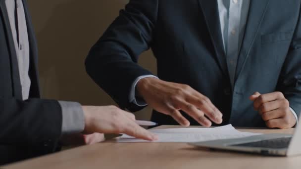 Άγνωστος Καυκάσιος επιχειρηματίας και Αφροαμερικάνος επενδυτής υπογράφοντας συμβόλαιο κάνουν χειραψία στο γραφείο. Κλείστε τα αρσενικά χέρια με χαρτιά έγγραφα χειραψία υπογραφή συμφωνία - Πλάνα, βίντεο