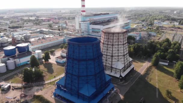 Quadrocopter shooting of a thermal power plant with large cooling towers against the background of transformers and power lines - Footage, Video
