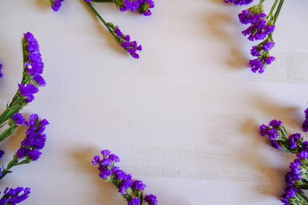 Rahmen aus lila Potpourri-Blumen auf weißem Hintergrund. Ansicht von oben. Kopierraum. Feiertage, Geburtstagsparty. - Foto, Bild