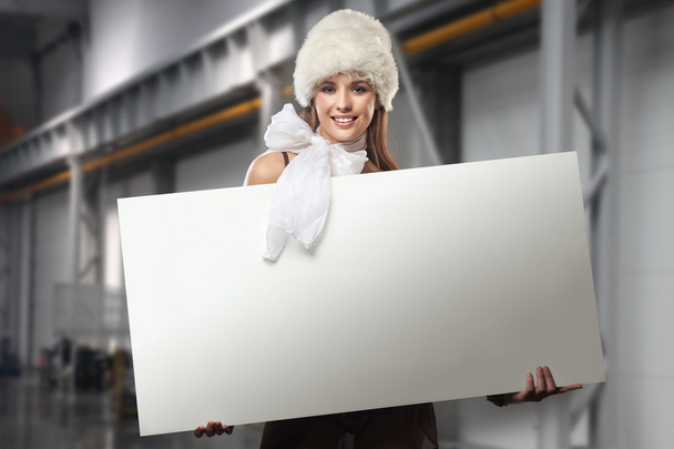 Smiling girl holding white blank - Valokuva, kuva