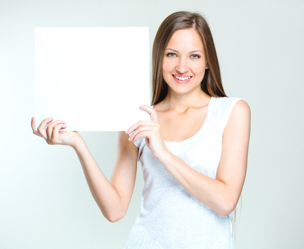 Happy woman holding blank poster - Fotoğraf, Görsel