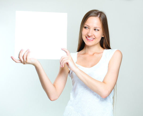 Happy woman holding blank poster - 写真・画像