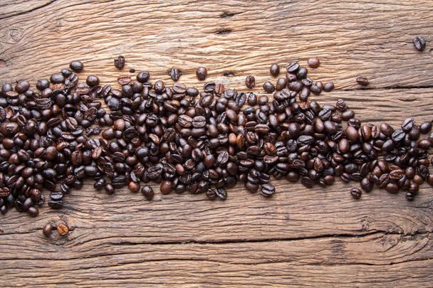 Coffee beans on wood background - Foto, afbeelding