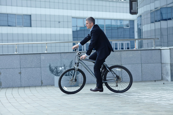 Active businessman riding a bicycle - Фото, зображення