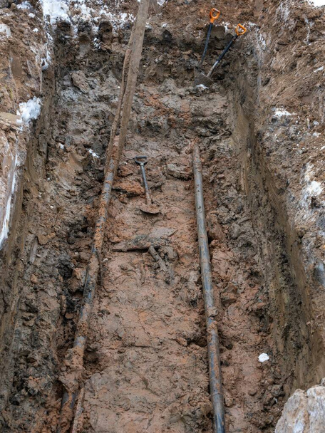 Civil infrastructure pipe, water lines and storm sewers. a pit dug for the repair and replacement of utilities. - Photo, Image