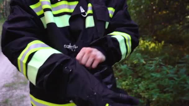 firefighter puts on combat clothing - Footage, Video