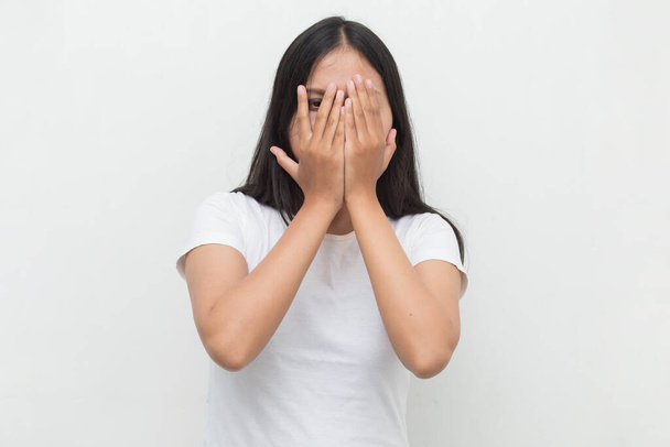Asian woman peek covers her face with her hands - Photo, Image