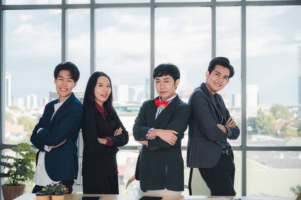 Group of confident and smart LGBT business people in formal attire sit at their desks. There's a laptop in the background. Concept of relaxation. The concept of diversity, race and culture. - Photo, Image