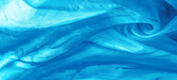 Blauer Stoff mit grauen Flecken auf türkisfarbenem Hintergrund. Abstrakter Designerstoff. Schöner Hintergrund für Ihr Design. Textur. Bild. Zeichnung, Muster, Figur - Foto, Bild