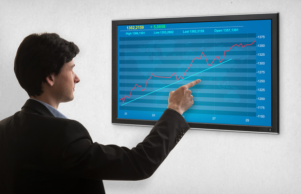 Businessman checking stock market on screen - Valokuva, kuva