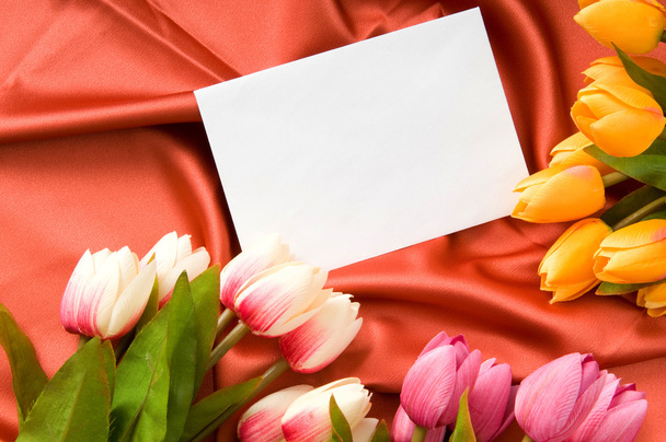 Envelope and flowers on the satin background - Valokuva, kuva