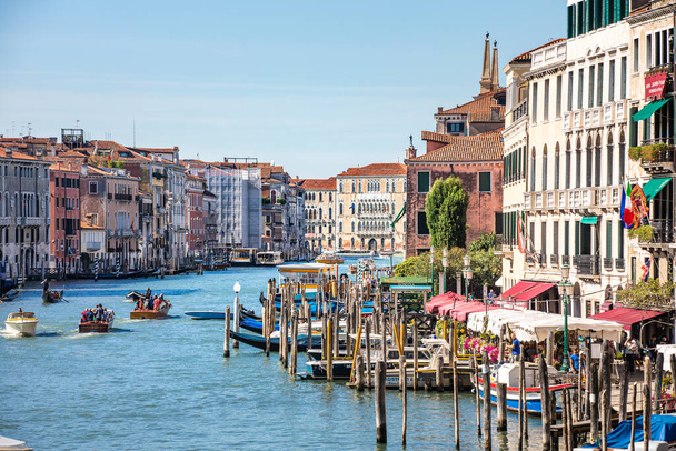 Venice, Italy - October  22, 2019 - Streets of the ancient city. Beautiful view of traditional gondola and boats on canal grande. Summer vacation and travel tourism scenery. Sunny weather in Venice - Foto, Imagem