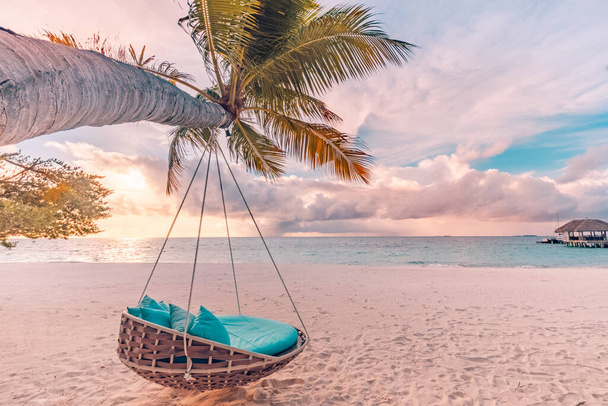 Tropical beach background as summer landscape with hammock and white sand and calm sea for beach banner. Perfect beach scene vacation and summer holiday concept. Boost up color process - Photo, Image