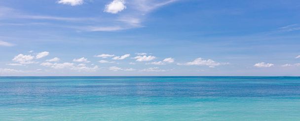 Beach and tropical sea. Stunning summer landscape, shore, coast with calm waves, relaxing seascape horizon over white sand blue sky. Tranquil nature pattern, beach concept. Travel vacation, copy space - Photo, Image