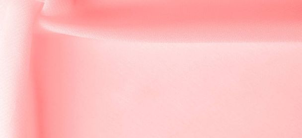 Texture. Contexte. tissu de soie rose rouge. une fibre fine, forte, douce et brillante produite par les vers à soie dans la fabrication de cocons et recueillie pour fabriquer du fil et du tissu. - Photo, image