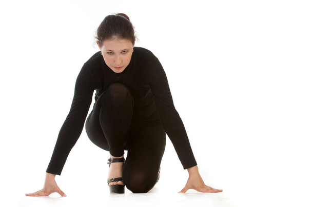 Studio photo of the model. Girl in a black elastic-fitting suit - Foto, Imagem