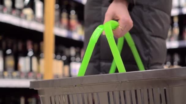 Uma mulher segura uma cesta em um supermercado close-up. - Filmagem, Vídeo