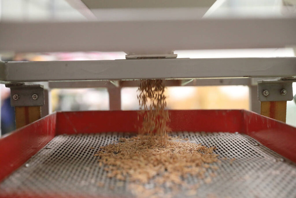 Factory machine Milling rice in close up - Foto, afbeelding