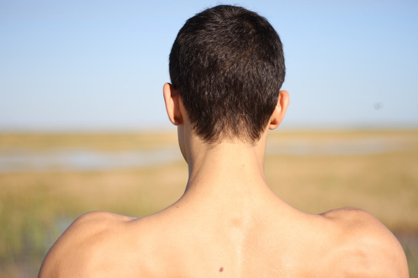 Back of young man in yoga position. outdoors - Photo, Image