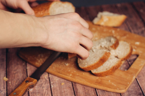 sliced fresh loaf on a wooden cutting board kitchen meal - Fotó, kép