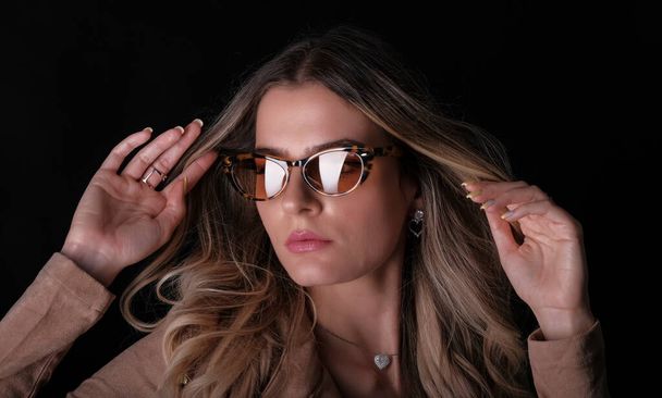 Italian girl with long blond hair posing with leather jacket and sunglasses. High quality photo - Fotoğraf, Görsel