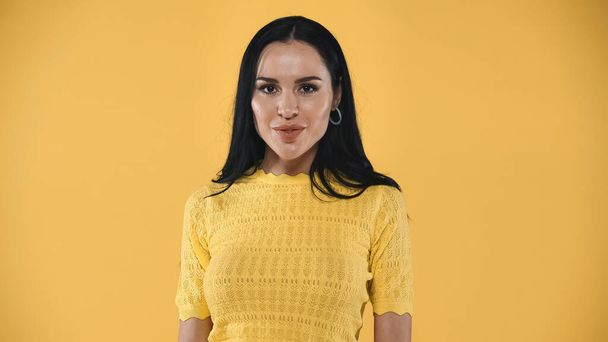 young, positive woman looking at camera isolated on yellow - Photo, Image