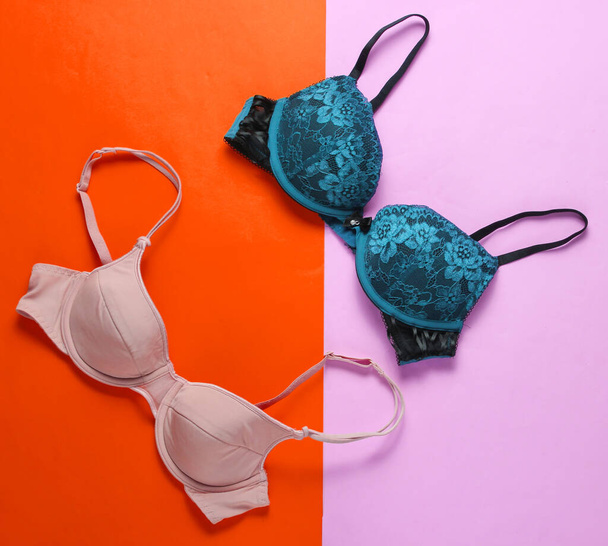 Two fashionable sexy women's bra on a pastel background. Beautiful underwear. Top view - Photo, Image