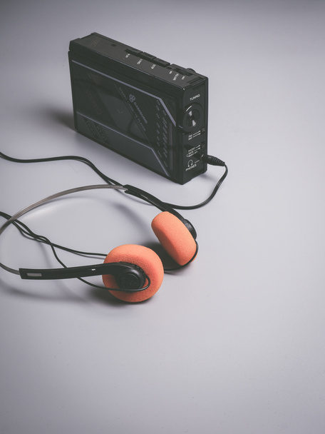 1980s walkman style cassette player and orange headphones grey background copy space - Photo, Image