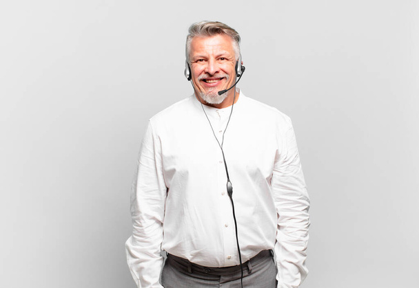 senior telemarketer looking happy and pleasantly surprised, excited with a fascinated and shocked expression - Fotografie, Obrázek