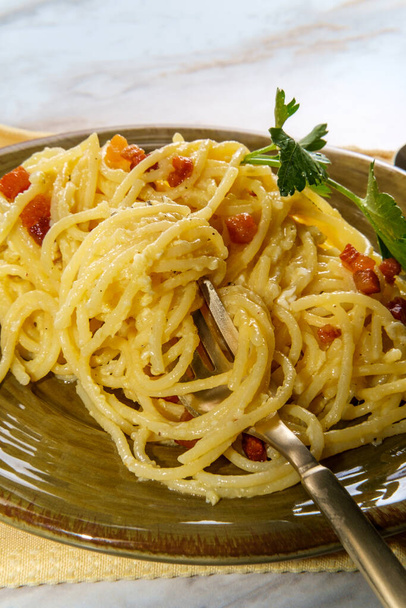 Creamy Italian cuisine spaghetti alla carbonara with pancetta and parsley garnish - Photo, Image