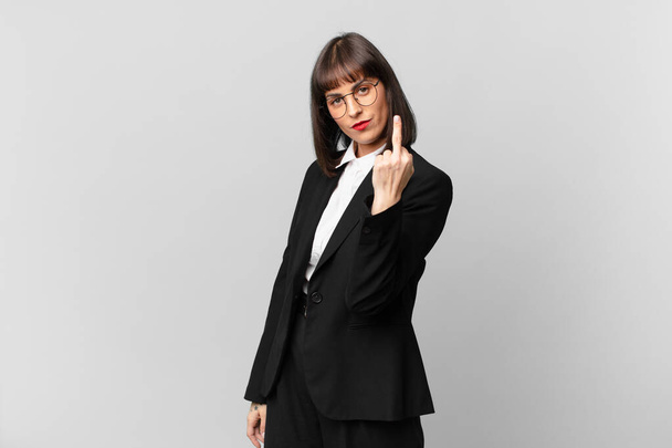 young businesswoman feeling angry, annoyed, rebellious and aggressive, flipping the middle finger, fighting back - Photo, Image