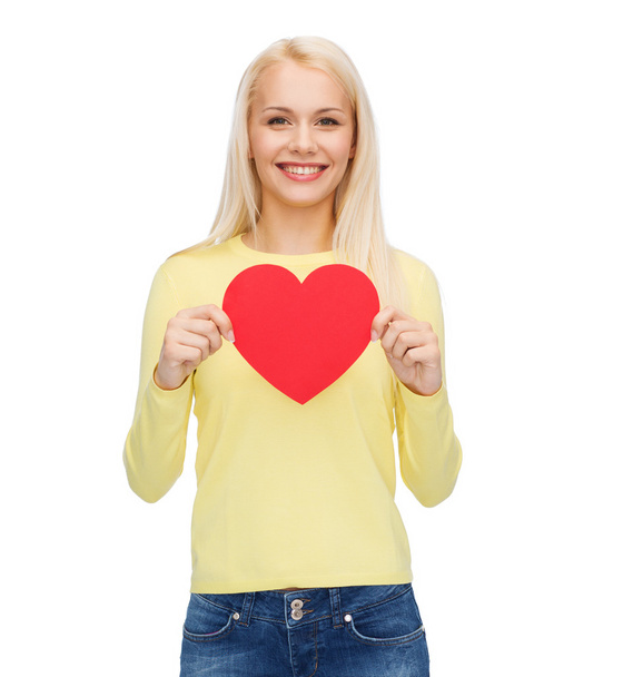 Smiling woman with red heart - Φωτογραφία, εικόνα