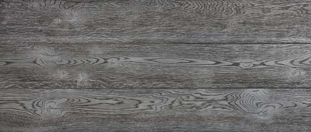 Black textured wooden background of horizontal planks with longitudinal fibers patterns and knots. Panoramic shot. - Photo, Image