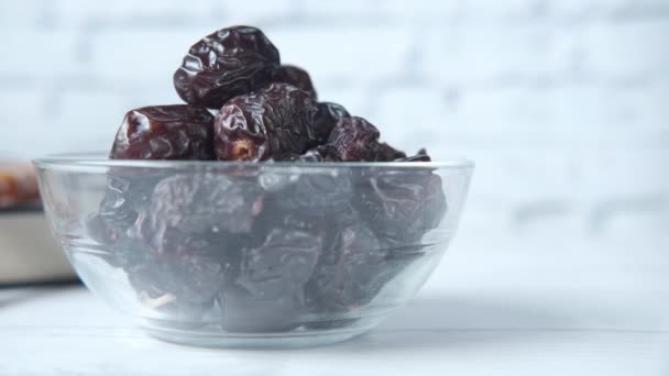 close up of fresh date fruit in a bowl and quran on table  - Footage, Video