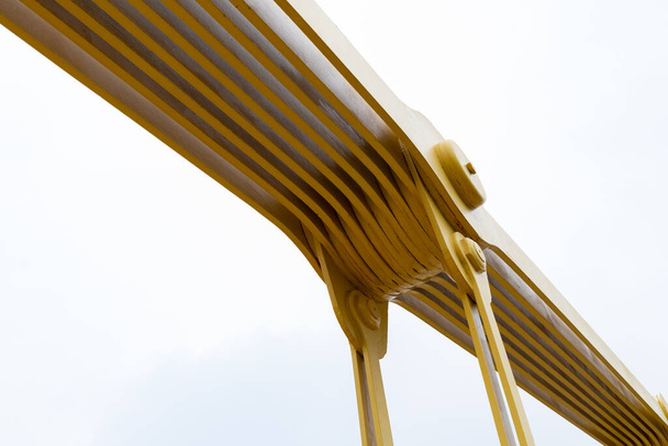 Detail kloubu v samostatně ukotveném visutém mostě natřeném jasně žlutým, vodorovným vzhledem - Fotografie, Obrázek