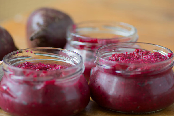 Bowls of homemade Red Chrain, a spicy paste made of grated Horseradish (Armoracia rusticana, syn. Cochlearia armoracia) and Beetroot, a traditional food of the Jewish Passover holiday - Photo, Image
