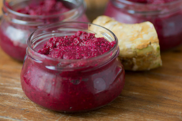 Bowl of homemade Red Chrain, a spicy paste made of grated Horseradish (Armoracia rusticana, syn. Cochlearia armoracia) and Beetroot, a traditional food of the Jewish Passover holiday - Photo, Image