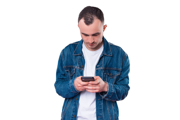 Photo of young man typing message on smartphone. - Photo, Image
