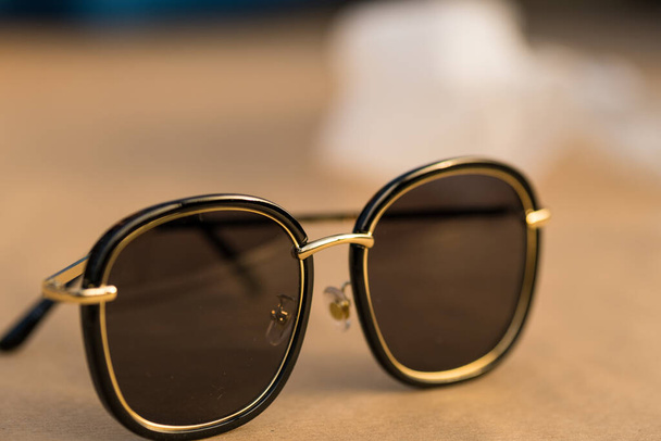 Las gafas de sol con grandes lentes redondas negras disparan al aire libre en un primer plano de día soleado. Enfoque selectivo - Foto, Imagen